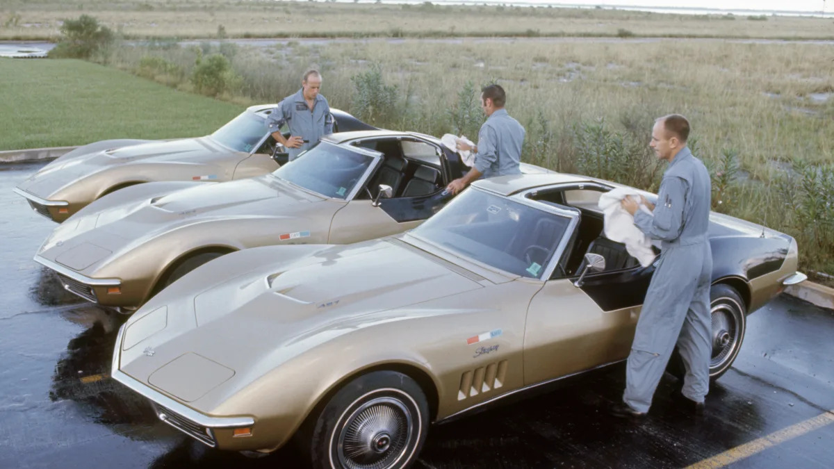 Portrait of the crew of Apollo 12 polish a trio of Chevrolet Corvette Stingrays, Cocoa Beach, Florida, September 23, 1969. The crew, NASA's second manned mission to the moon, was, from left, astronauts Pete Conrad