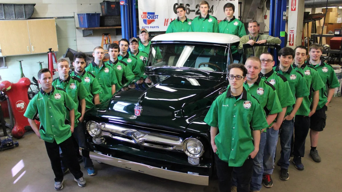 Students pose next to the finished '56 Ford truck.
