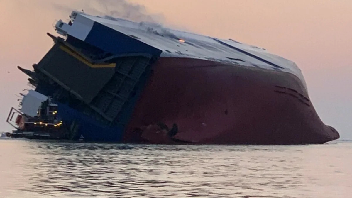 Coast Guard crews and port partners respond to an overturned cargo vessel with a fire on board Sunday, Sept. 8, 2019, in St. Simons Sound, Ga. (U.S. Coast Guard via AP)