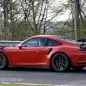 Mark Webber does promotional work in the new Porsche 911 GT3 RS at the Nuerburgring, rear three-quarter view.