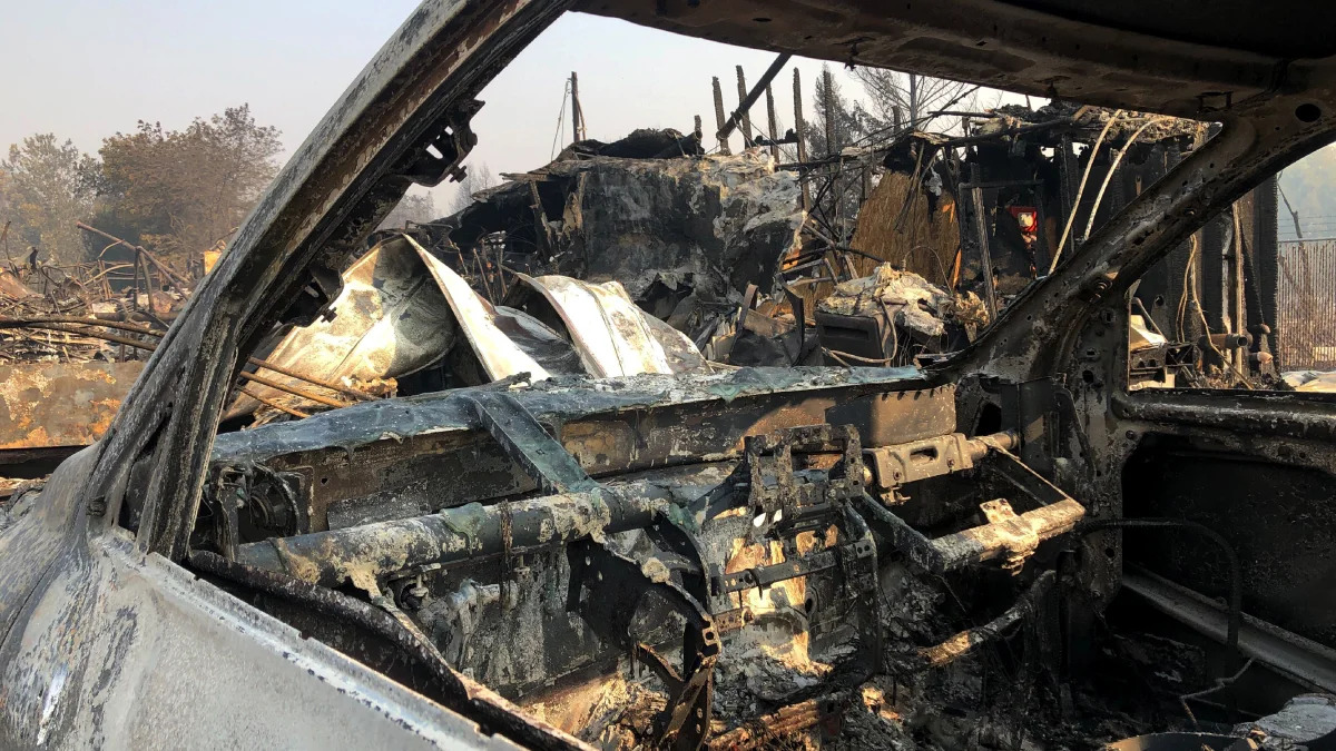 The interior of a vehicle is melted among the ruins of the Coleman Creek Estates mobile home park in Phoenix, Ore., Thursday, Sept. 10, 2020. The area was destroyed when a wildfire swept through on Tuesday, Sept. 8.. (AP Photo/Gillian Flaccus)
