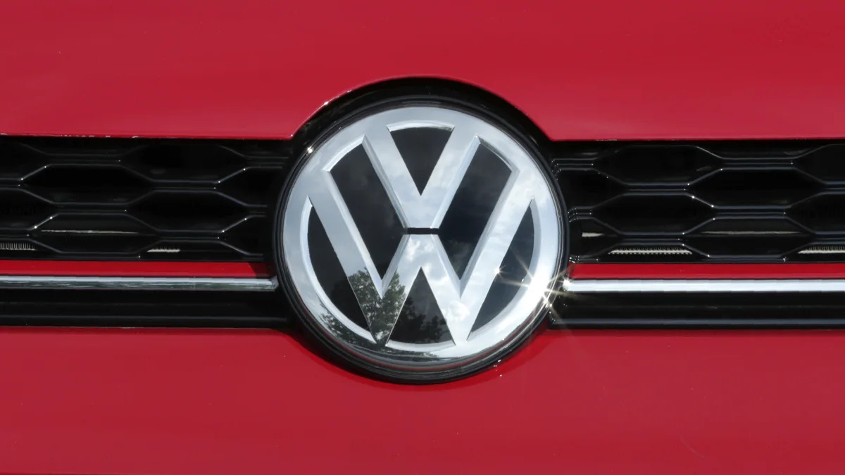 The Volkswagen logo on a Golf GTI catches a reflection of the sun at the Quirk dealership in Manchester, N.H., Wednesday, July 10, 2019. (AP Photo/Charles Krupa)