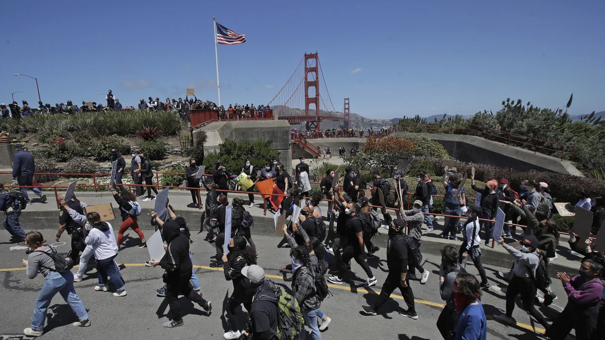 Marchers walk to the Golden Gate Bridge in San Francisco, Saturday, June 6, 2020, at a protest over the Memorial Day death of George Floyd. Floyd died May 25 after being restrained by Minneapolis police. (AP Photo/Jeff Chiu)