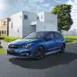 blue subaru impreza sport hybrid in front of house