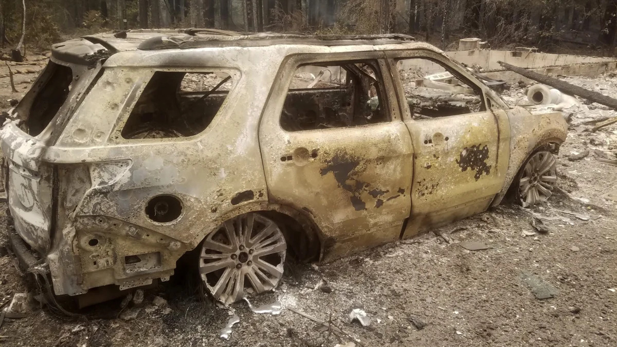 A burned out car is seen near someone's home after the passing of the Holiday Farm fire in McKenzie Bridge, Oregon on September 10, 2020. - California firefighters battled the state's largest ever inferno on September 10, as tens of thousands of people fled blazes up and down the US West Coast and officials warned the death toll could shoot up in coming days. At least eight people have been confirmed dead in the past 24 hours across California, Oregon and Washington, but officials say some areas are still impossible to reach, meaning the number is likely to rise. (Photo by Tyee Burwell / AFP) (Photo by TYEE BURWELL/AFP via Getty Images)