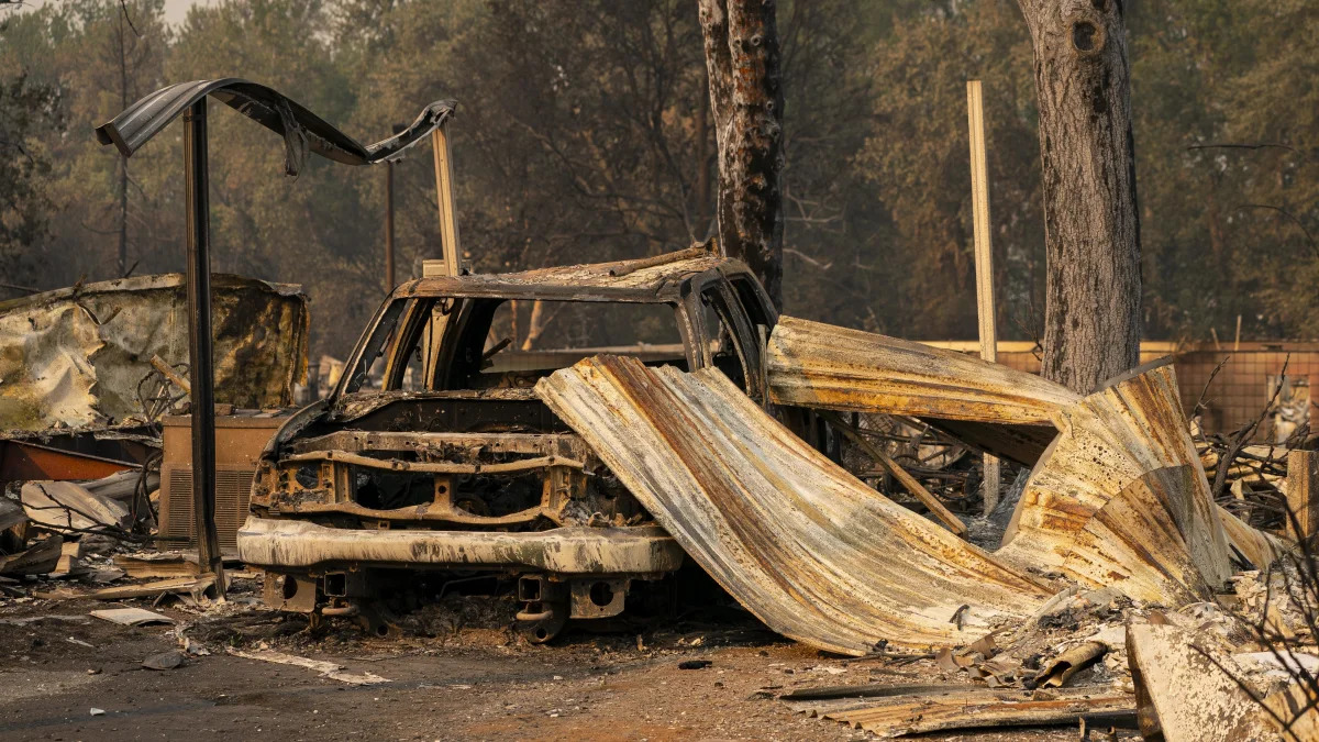 PHOENIX, OR - SEPTEMBER 10: A damaged home and car are seen in a mobile home park destroyed by fire on September 10, 2020 in Phoenix, Oregon. Hundreds of homes in the town have been lost due to wildfire. (Photo by David Ryder/Getty Images)