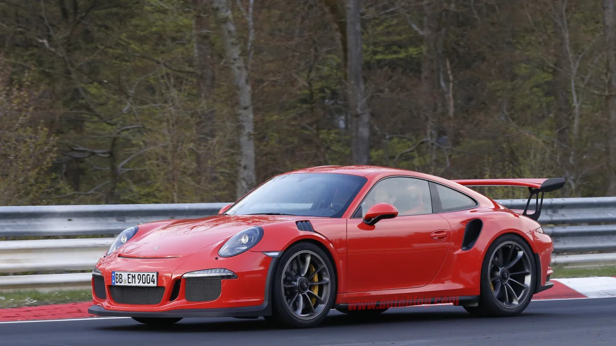 Mark Webber does promotional work in the new Porsche 911 GT3 RS at the Nuerburgring, front three-quarter view.