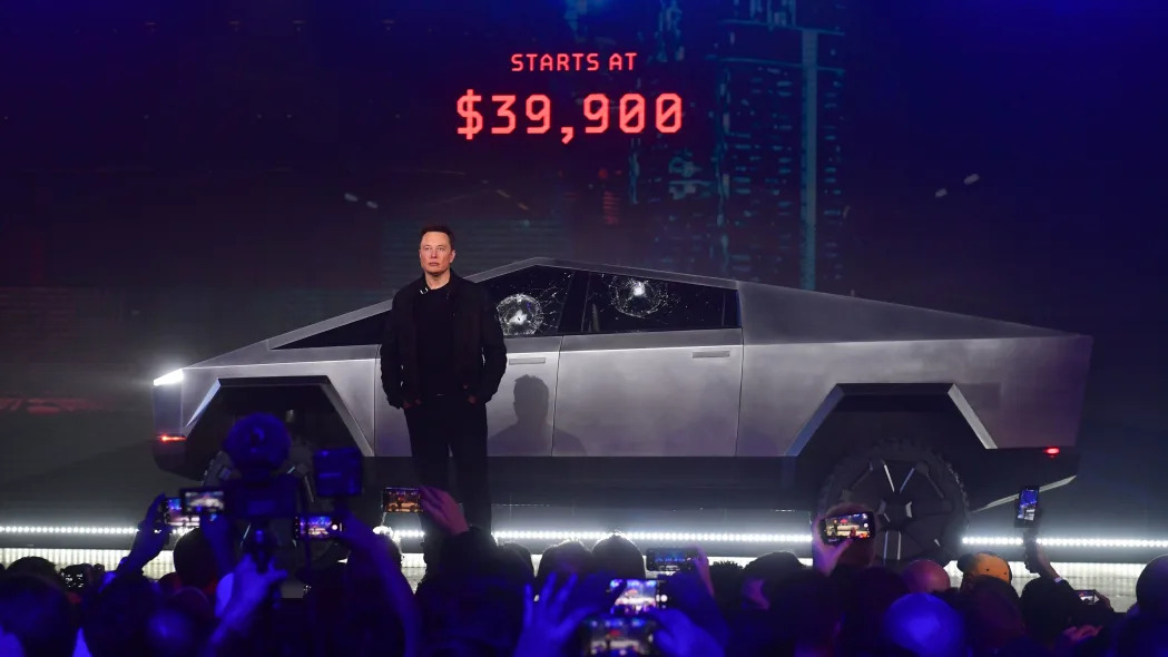 Tesla co-founder and CEO Elon Musk stands in front of the all-electric Tesla's Cybertruck.