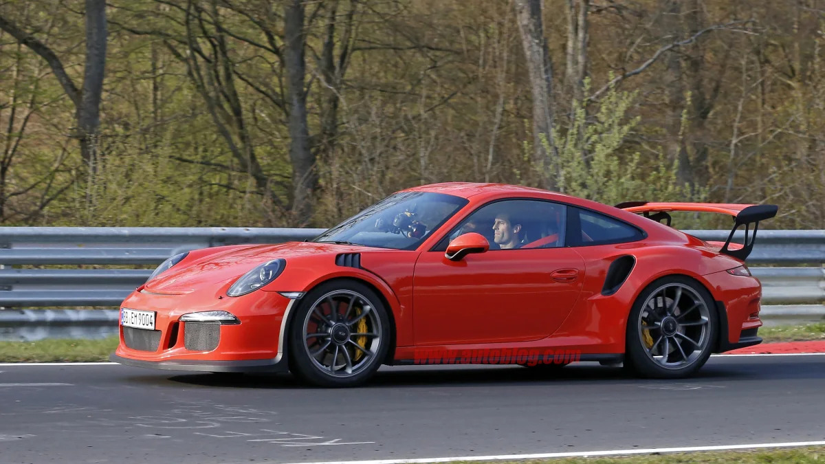 Mark Webber does promotional work in the new Porsche 911 GT3 RS at the Nuerburgring, side view.