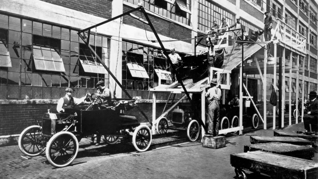 View of a portion of the assembly line for Model T automobiles at a Ford manufacturing plant (probably the one in Highland Park, Michigan), 1913.