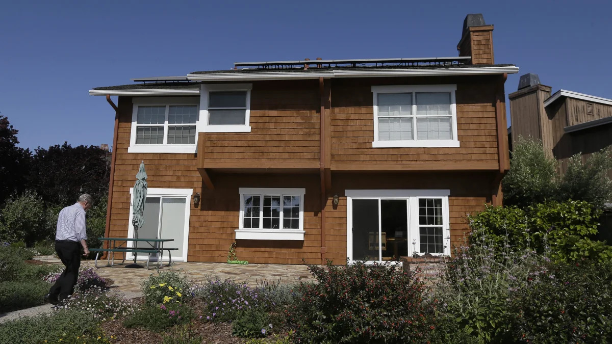 Solar panels on house with Tesla home battery.