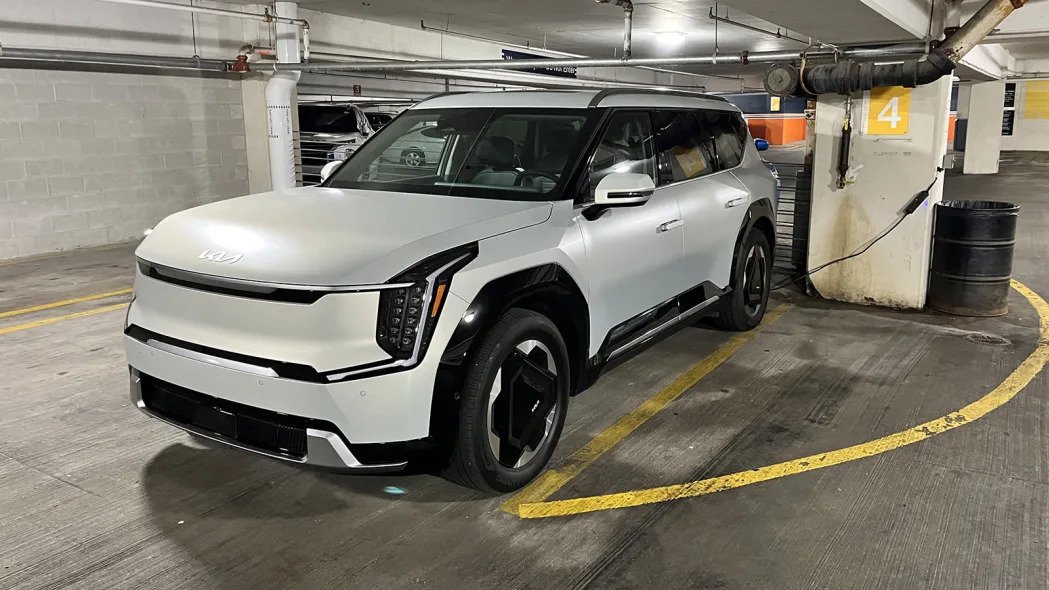Kia EV9 plugged into a 120-volt outlet in a parking garage