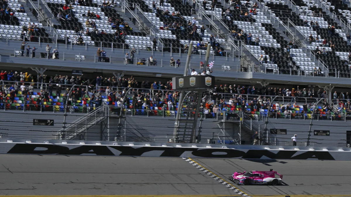 DAYTONA, FL - JANUARY 30: The #60 Meyer Shank Racing W/Curb-Agajanian Acura DPi in the DPi class driven by Oliver Jarvis, Tom Blomqvist, Helio Castroneves and Simon Pagenaud takes the checkered flag winning the IMSA Rolex 24  on January 30, 2022 at Daytona International Speedway Road Course in Daytona, FL. (Photo by Gavin Baker/Icon Sportswire via Getty Images)