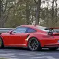 Mark Webber does promotional work in the new Porsche 911 GT3 RS at the Nuerburgring, rear three-quarter view.