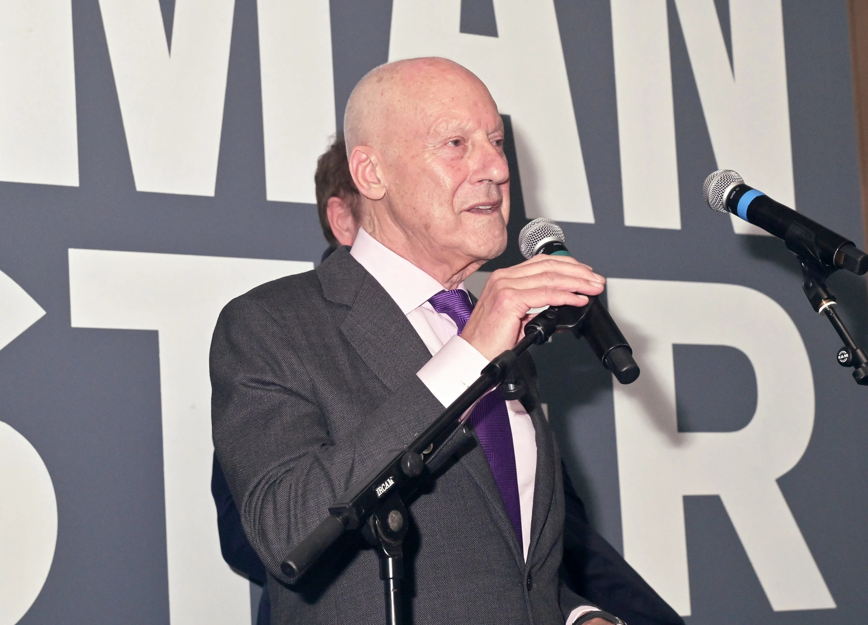 Architect Norman Foster speaks at a podium