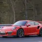 Mark Webber does promotional work in the new Porsche 911 GT3 RS at the Nuerburgring, front three-quarter view.
