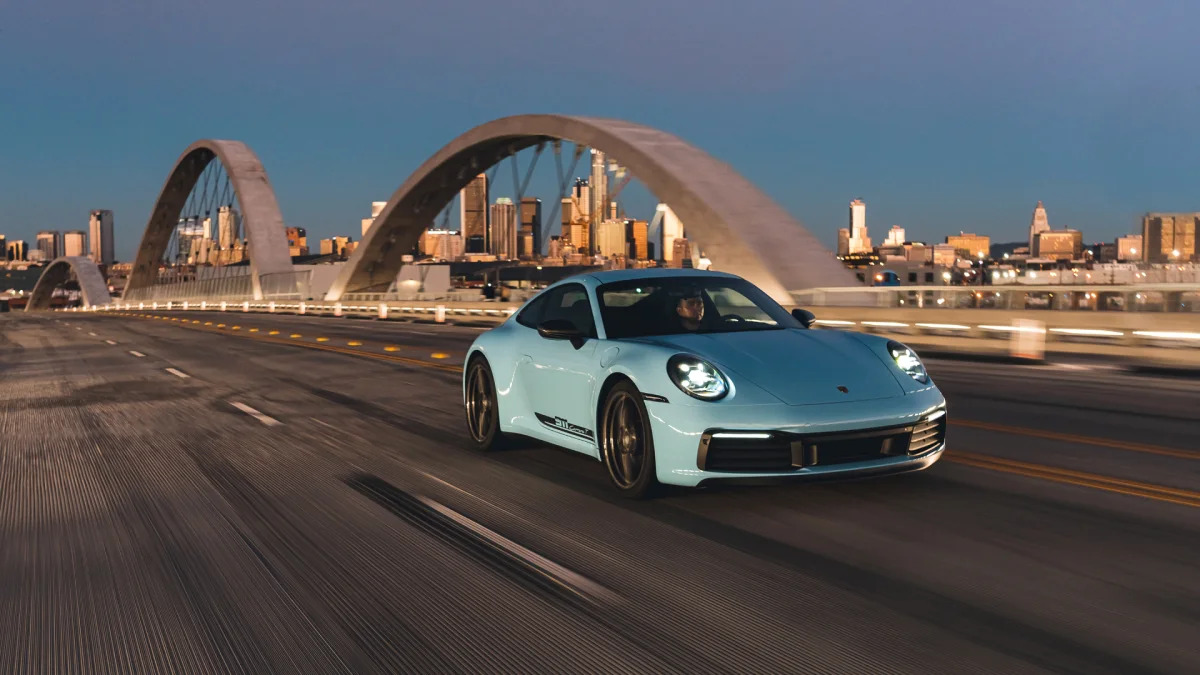 2023 Porsche 911 Carrera T in Gulf Blue action front three quarter downtown