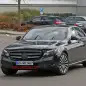 The 2017 Mercedes-Benz E-Class, front three-quarter view with camouflage.