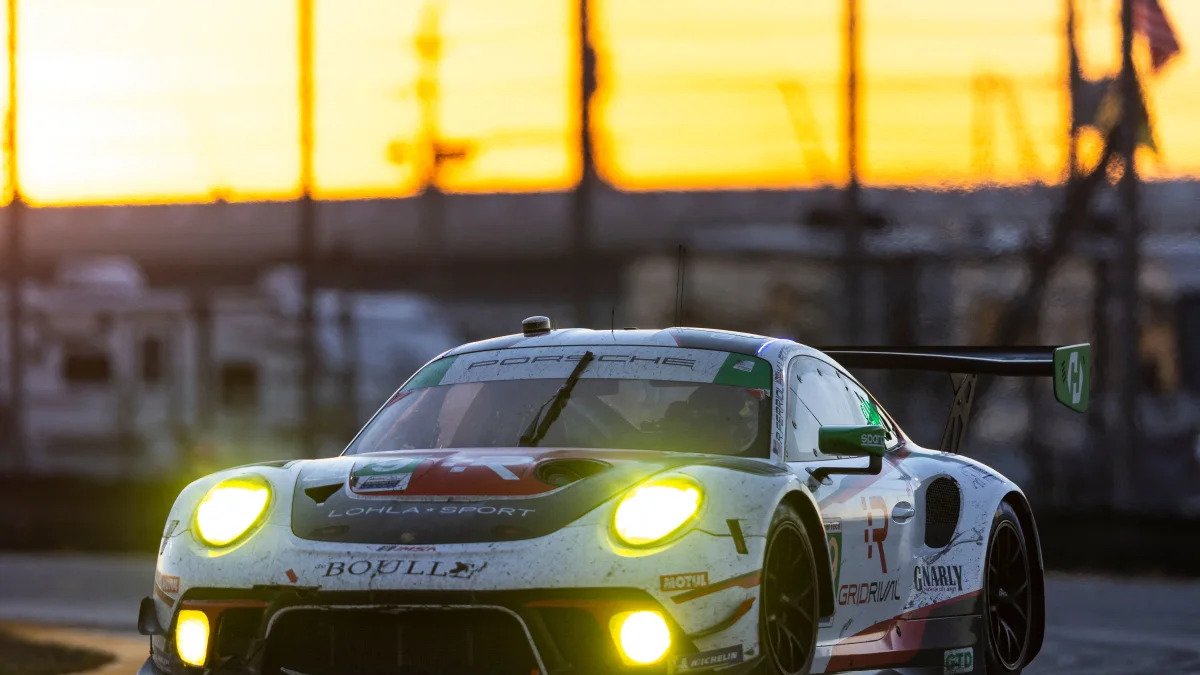 DAYTONA BEACH, FLORIDA - JANUARY 30: The #99 Team Hardpoint Porsche 911 GT3R of Rob Ferriol, Katherine Legge, Stefan Wilson, and Nick Boulle drives during sunrise at the Rolex 24 at Daytona International Speedway on January 30, 2022 in Daytona Beach, Florida.   James Gilbert/Getty Images/AFP / AFP / GETTY IMAGES NORTH AMERICA / James Gilbert
