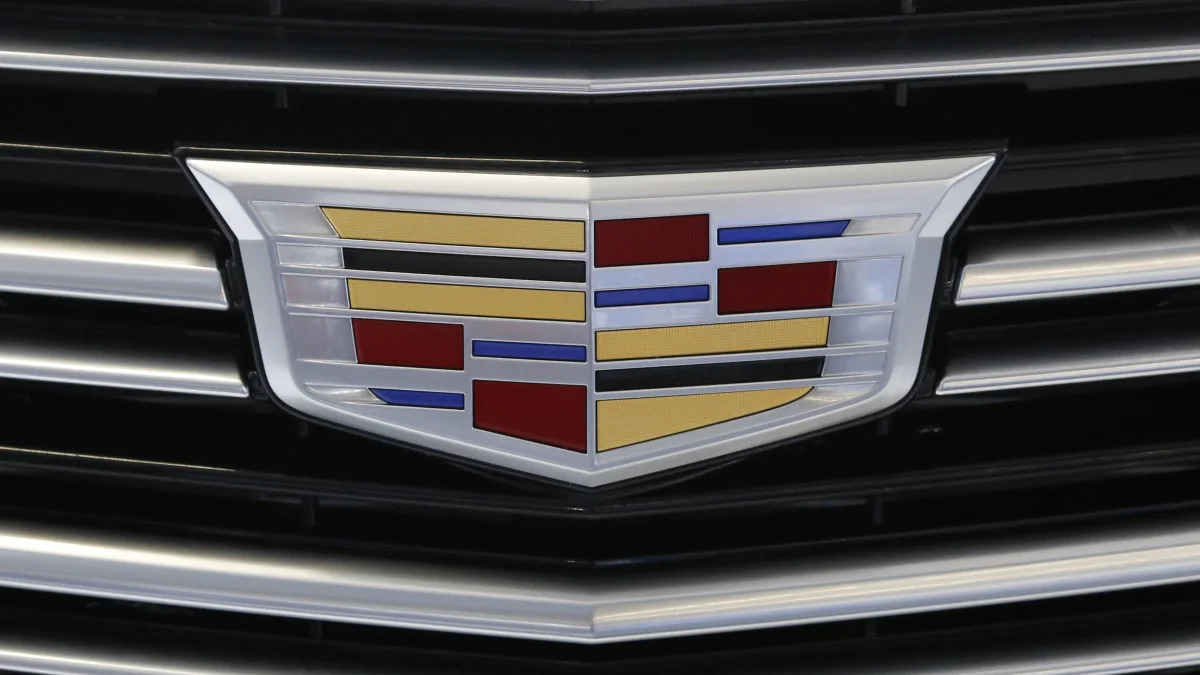 This is a the Cadillac logo on the grill of a Cadillac 2016 XT5 automobile on display at the Pittsburgh International Auto Show in Pittsburgh Thursday, Feb. 11, 2016. (AP Photo/Gene J. Puskar)