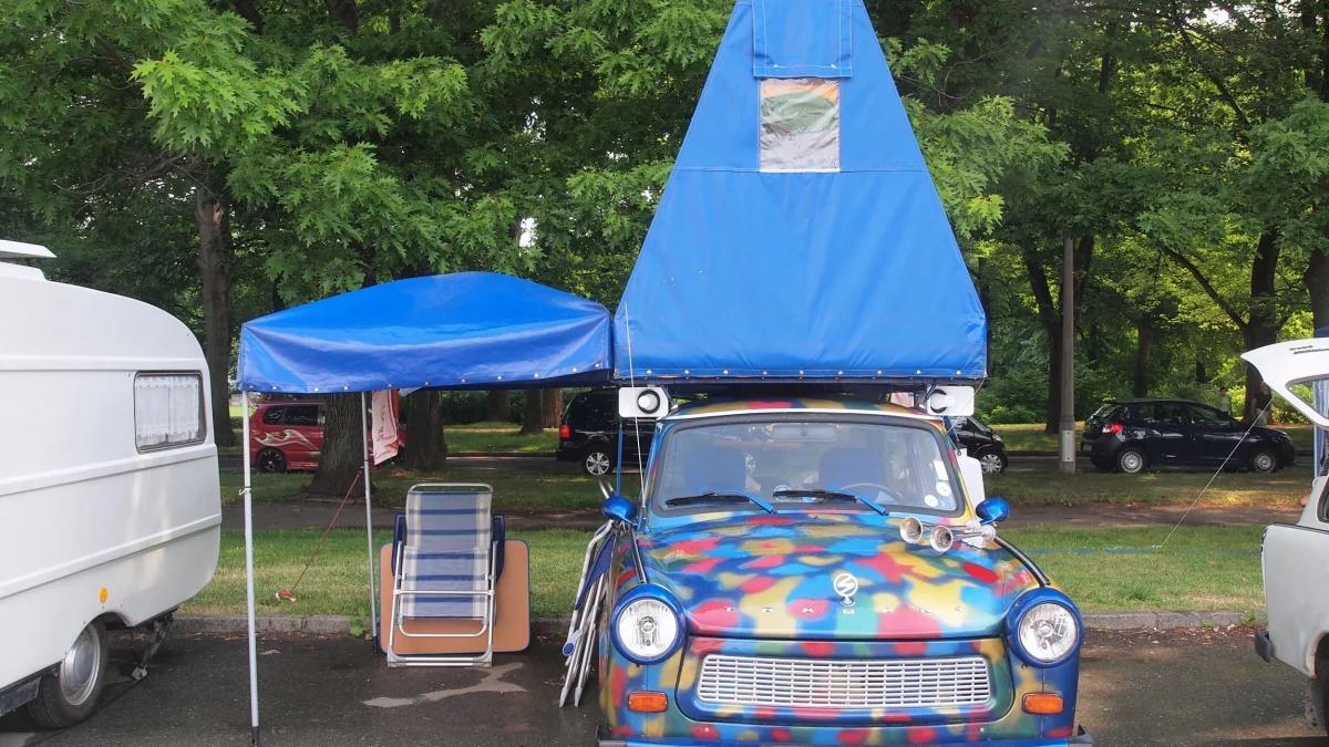 A rainbow Trabi with a blue tent on top at the 2015 Trabant Fest in Zwickau, Germany.