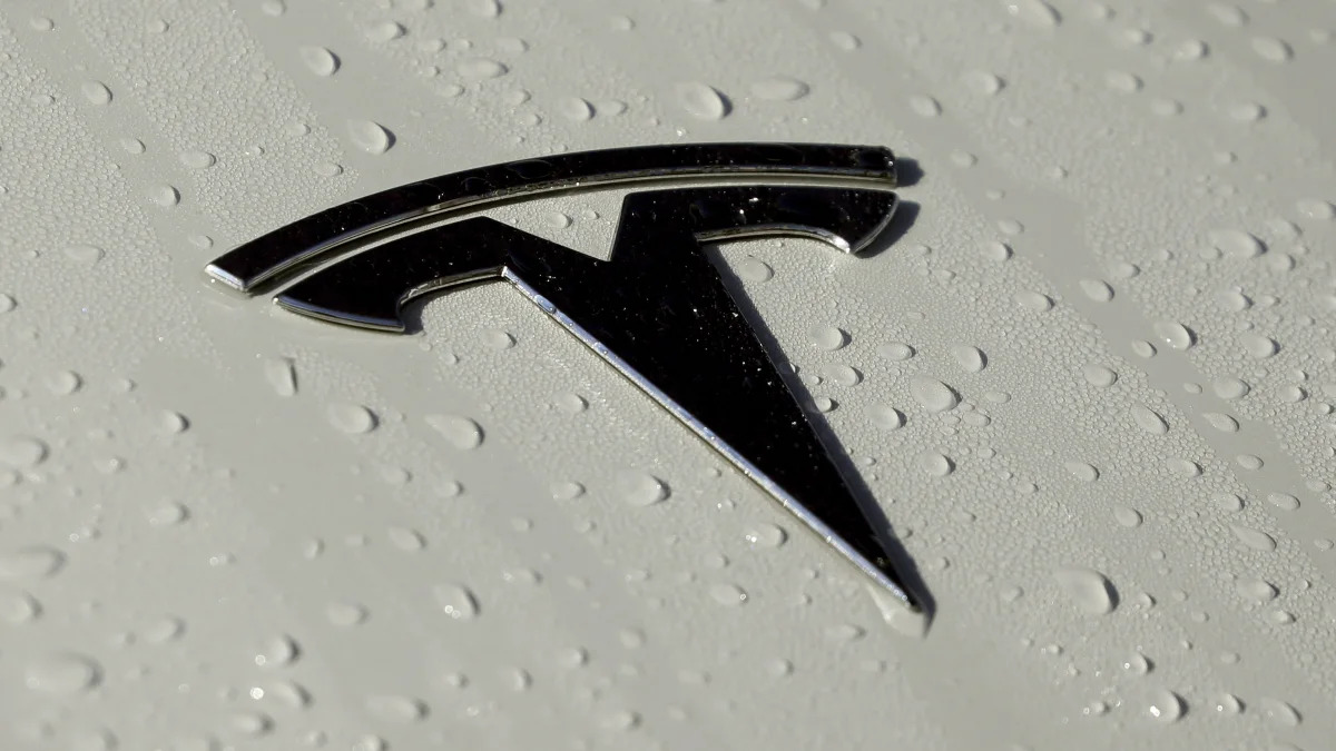 This Oct. 18, 2019, photo shows a Tesla logo in Salt Lake City. Tesla reports financial earns on Wednesday, Oct. 23. (AP Photo/Rick Bowmer)