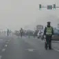 China Environment Vs Economy (In this Thursday, March 7, 2013 Chinese traffic policemen closed off a road for delegation buses attending the annual Chinese People's Political Consultative Conference h