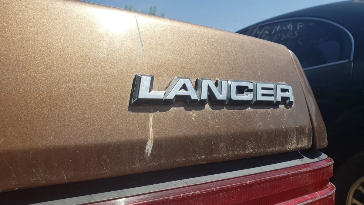 06 - 1986 Dodge Lancer in Colorado wrecking yard - photo by Murilee Martin