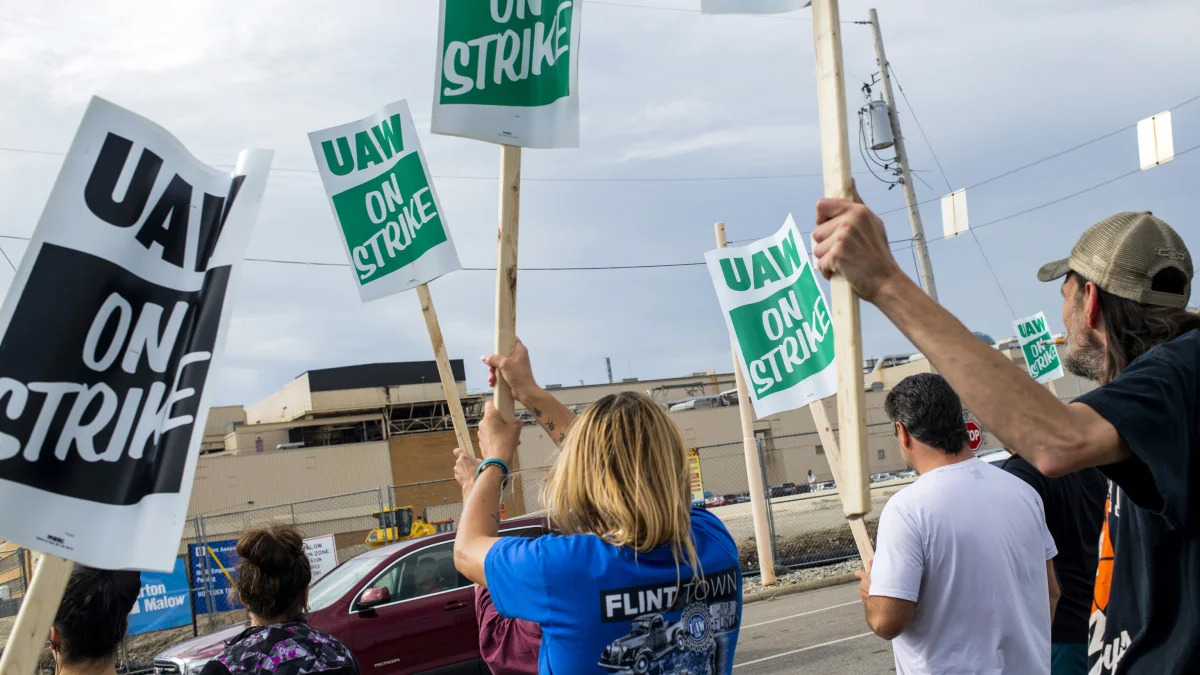 General Motors employees demonstrate outside the Flint Assembly Plant on Sunday, Sept. 15, 2019, in Flint, Mich. The United Auto Workers union says its contract negotiations with GM have broken down and its members will go on strike just before midnight on Sunday.  (Jake May/The Flint Journal via AP)