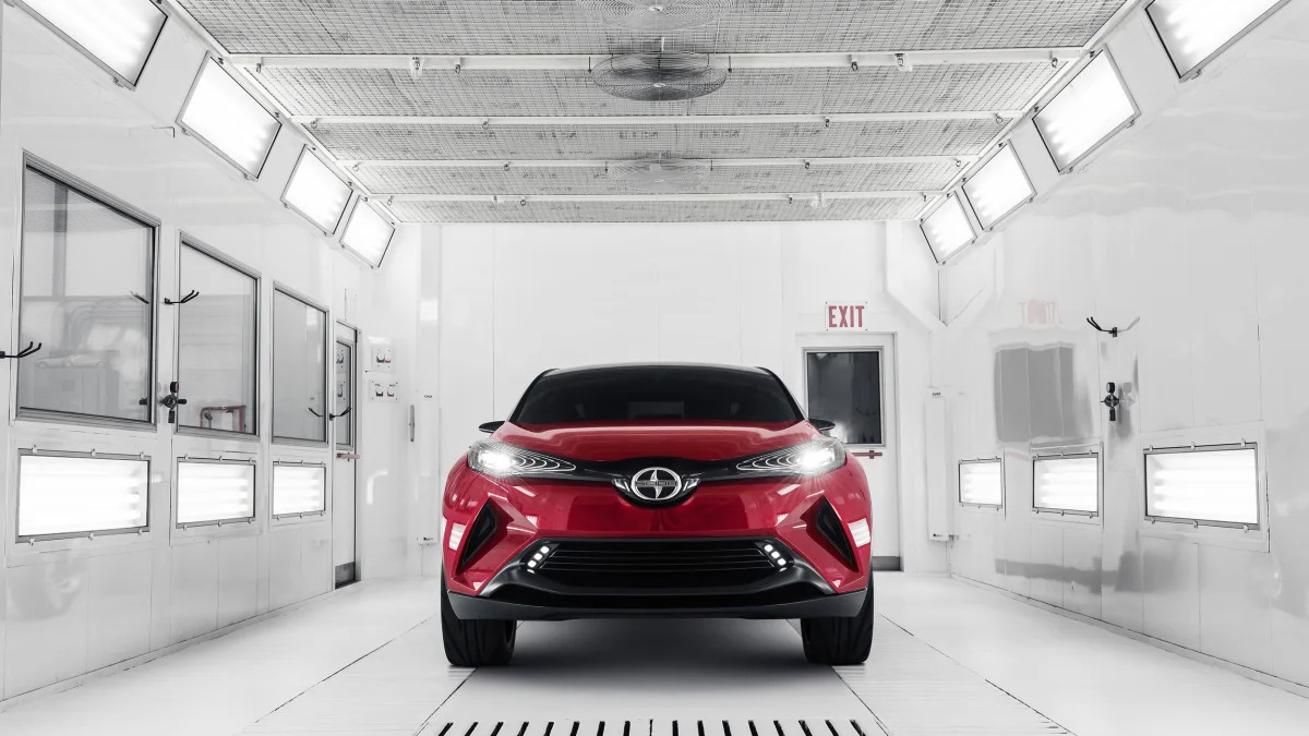 The Scion C-HR concept shown off in red for the LA Auto Show, front view indoors.