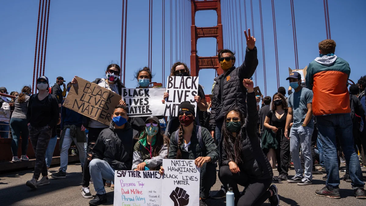 Protesters pose with Black Lives Matter signs on the Golden Gate Bridge during a demonstration against racism and police brutality in San Francisco, California, on June 6, 2020. - Demonstrations are being held across the US following the death of George Floyd on May 25, 2020, while being arrested in Minneapolis, Minnesota. (Photo by Vivian LIN / AFP) (Photo by VIVIAN LIN/AFP via Getty Images)