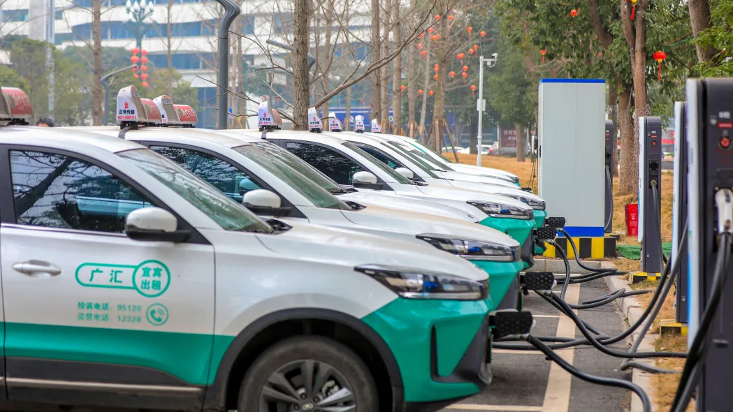 Electric taxis charge batteries at a charging station on February 7, 2023 in Yibin, Sichuan, China.