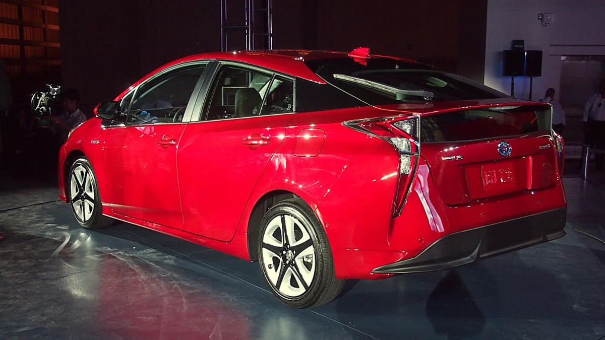 2016 Toyota Prius red, at reveal event, rear 3/4