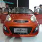 Yogomo 330 EV (Chinese clone of Kia Picanto) in orange, front shot.