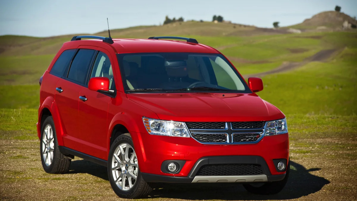 red 2015 dodge journey in a field