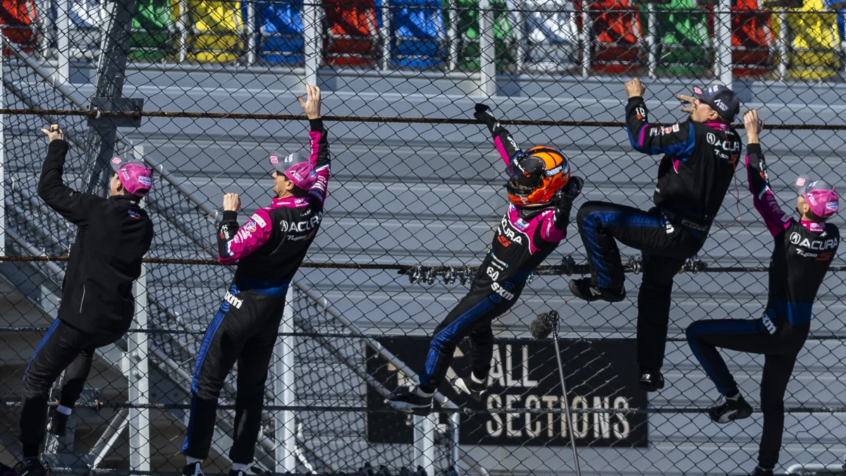 DAYTONA BEACH, FLORIDA - JANUARY 30: Helio Castroneves of Brazil, driver of the #60 Meyer Shank Racing w/ Curb-Agajanian Acura DPi, celebrates with his team after winning the Rolex 24 at Daytona International Speedway on January 30, 2022 in Daytona Beach, Florida. (Photo by James Gilbert/Getty Images)