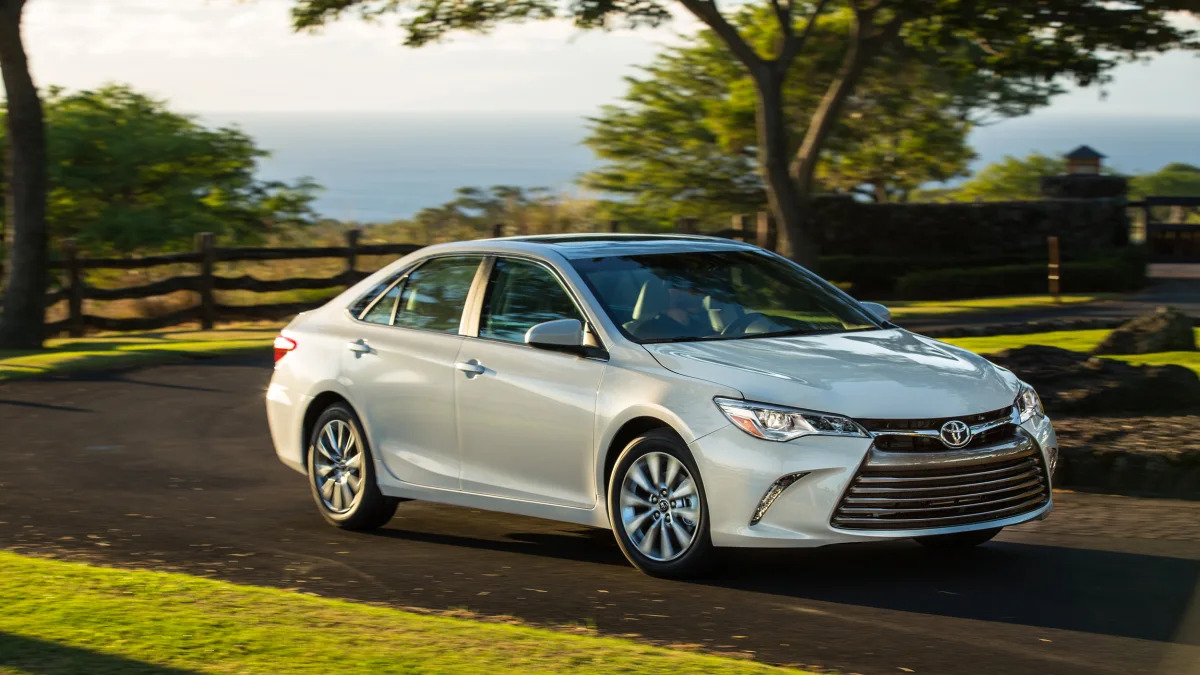 2015 Toyota Camry in silver on a winding road