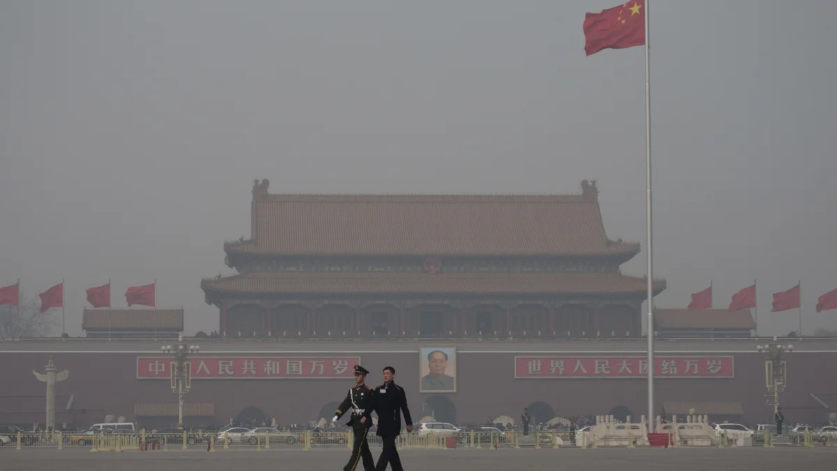 China Environment Vs Economy (In this Friday, March 8, 2013 Chinese paramilitary policemen march across Tiananmen Square on a hazy day in Beijing, China. Facing public outrage over smog-choked cities 