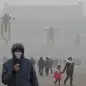 Japan China Smog (FILE - In this Tuesday, Jan. 29, 2013 file photo, a man wears a mask on Tiananmen Square in thick haze in Beijing. Japan's Foreign Ministry says it is seeking to cooperate and exchan