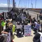 Dozens of people kneel after marching across the Golden Gate Bridge in support of the Black Lives Matter movement in San Francisco Saturday, June 6, 2020. People are protesting the death of George Floyd, who died after he was restrained by Minneapolis police on May 25 in Minnesota. (AP Photo/Jeff Chiu)