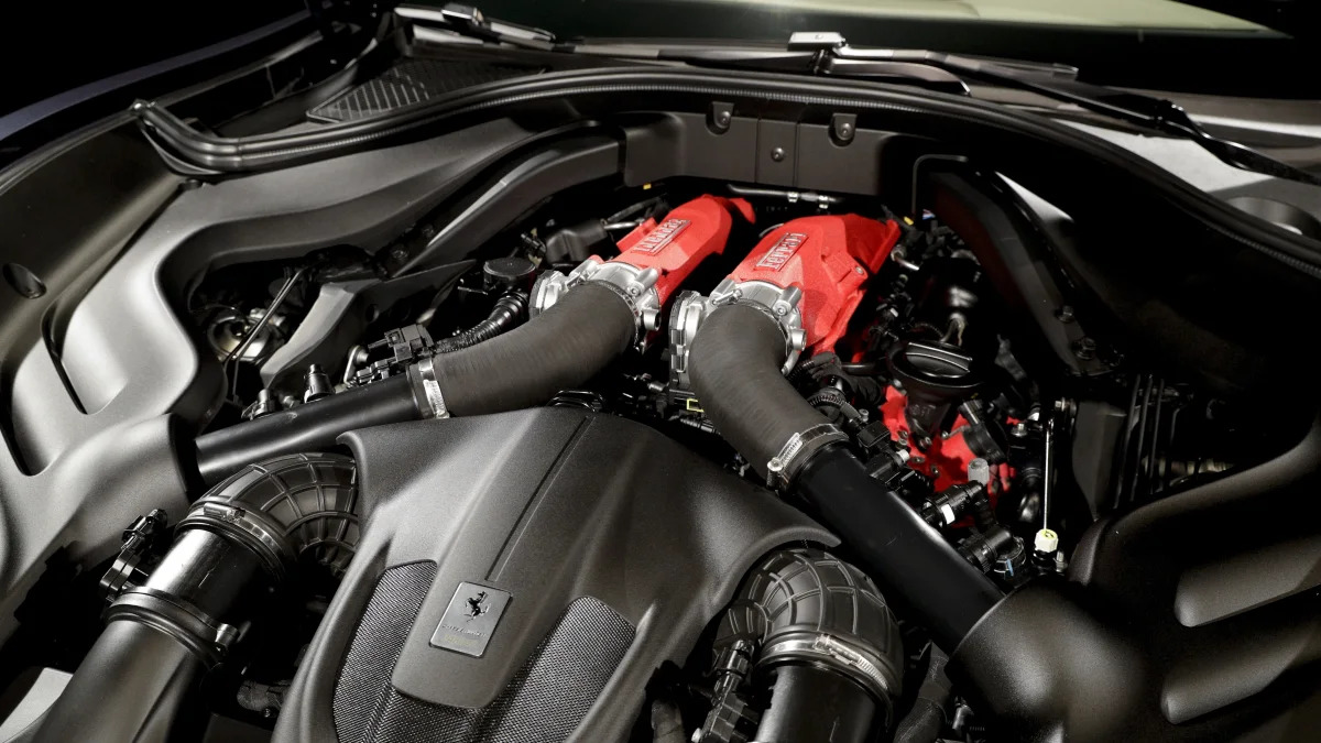 A view of the engine of the Ferrari Roma car that was unveiled in Rome, Thursday, Nov. 14, 2019. Ferrari unveils a new sports coupe aimed at enticing entry-level buyers and competing with the Porsche 911, part of a complete refresh of its model lineup by 2022. (AP Photo/Gregorio Borgia)