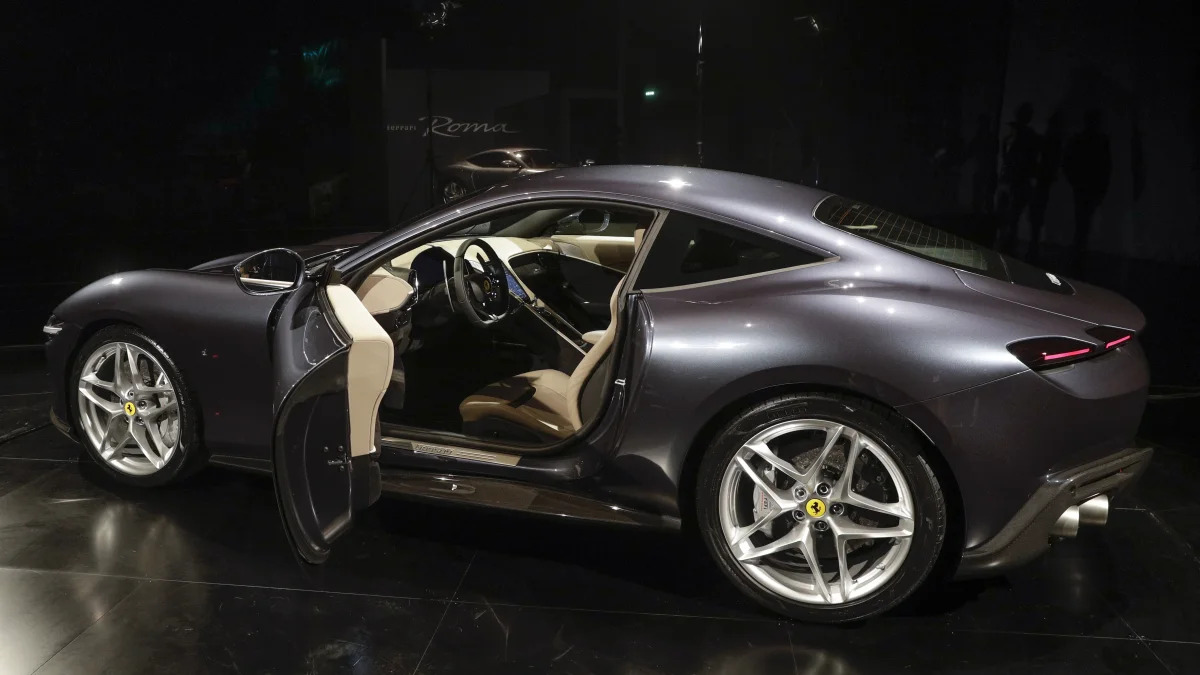 The Ferrari Roma car is unveiled in Rome, Thursday, Nov. 14, 2019, 2019. Ferrari unveils a new sports coupe aimed at enticing entry-level buyers and competing with the Porsche 911, part of a complete refresh of its model lineup by 2022. (AP Photo/Gregorio Borgia)