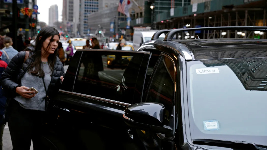 A passenger enters an Uber car in New York City, New York, U.S., December 6, 2019.
