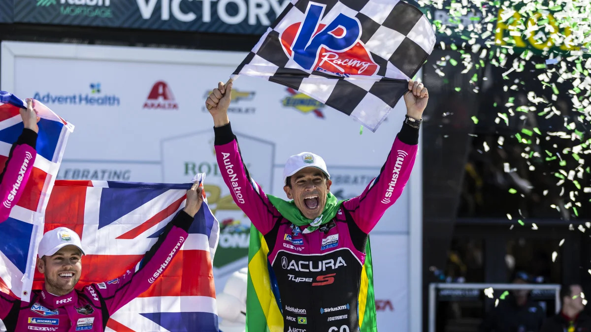 DAYTONA BEACH, FLORIDA - JANUARY 30: Helio Castroneves of Brazil, driver of the #60 Meyer Shank Racing w/ Curb-Agajanian Acura DPi celebrates with his team in victory lane after winning the Rolex 24 at Daytona International Speedway on January 30, 2022 in Daytona Beach, Florida. (Photo by James Gilbert/Getty Images)