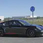 Spy shot of the next-generation 992-model Porsche 911 thought to hide a hybrid powertrain, side view.