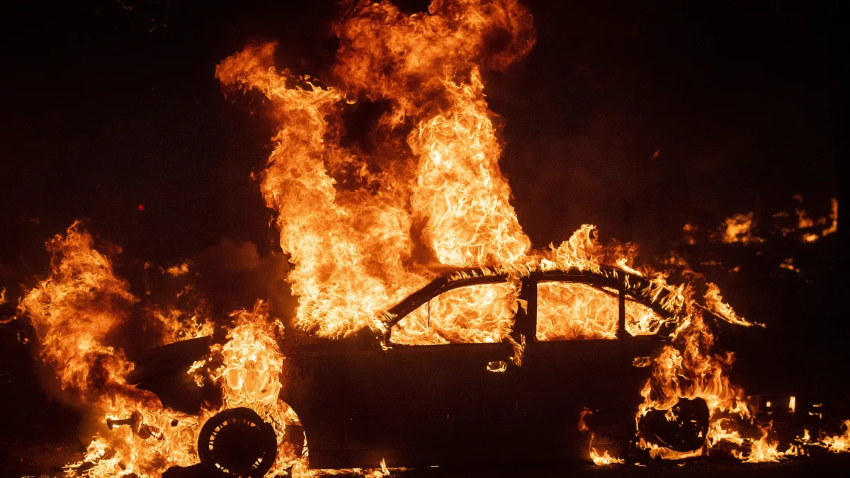 Flames from the Kincade Fire consume a car in the Jimtown community of unincorporated Sonoma County, Calif., on Thursday, Oct. 24, 2019. (AP Photo/Noah Berger)