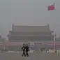 China Environment Vs Economy (In this Friday, March 8, 2013 Chinese paramilitary policemen march across Tiananmen Square on a hazy day in Beijing, China. Facing public outrage over smog-choked cities 