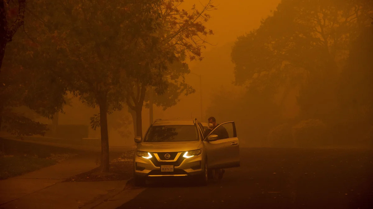 Smoke hangs over a residential neighborhood as a wildfire called the Kincade Fire burns in Healdsburg, Calif., Sunday, Oct. 27, 2019. (AP Photo/Noah Berger)
