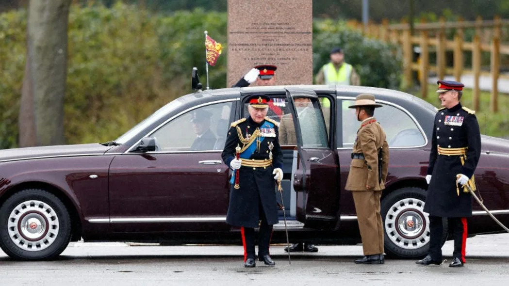 King Charles exits his Bentley State Limousine surrounded by soldiers