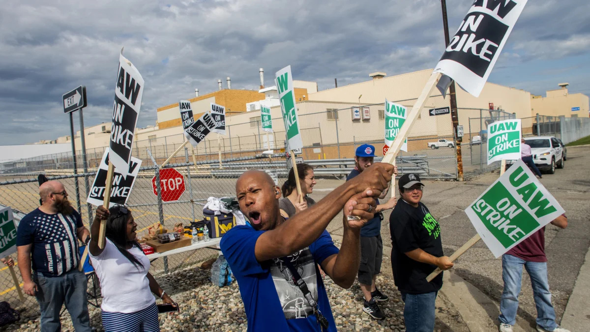 Flint resident Jashanti Walker, who has been a first shift team leader in the body shop for two years, demonstrates with more than a dozen other General Motors employees outside of the Flint Assembly Plant on Sunday, Sept. 15, 2019, in Flint, Mich. The United Auto Workers union says its contract negotiations with GM have broken down and its members will go on strike just before midnight on Sunday.  (Jake May/The Flint Journal via AP)